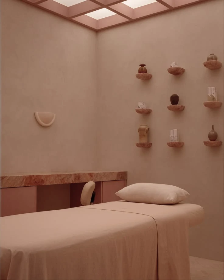 Soft pink studio interior with a curved sofa and wall details